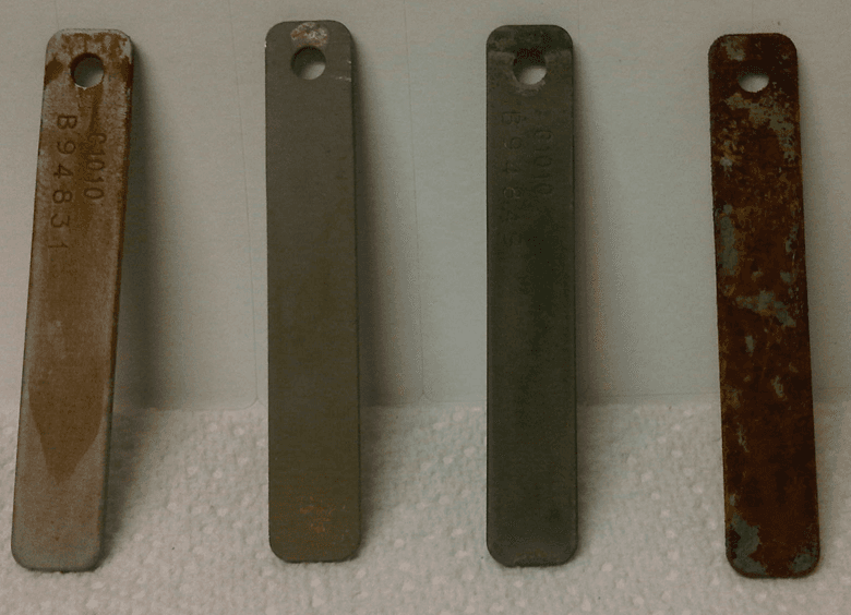 Metal corrosion coupons after immersion testing — progressively protected by SCL 8054.