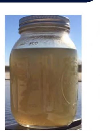 SWD tank 20 hours after startup of SSC treatment — clean fluid where tank-bottom solids used to accumulate.